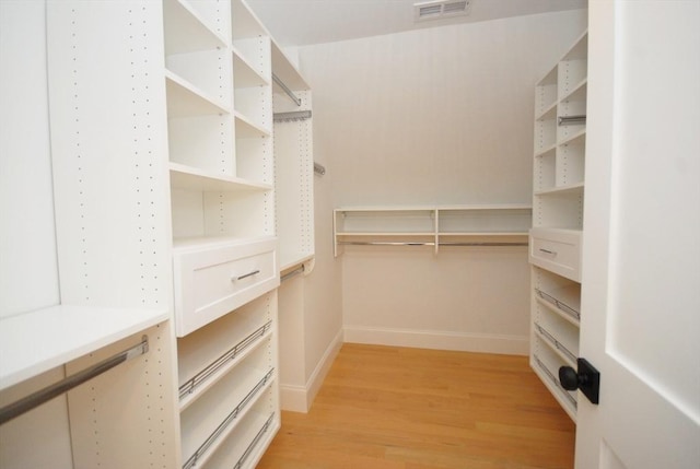 spacious closet with visible vents and light wood-style flooring