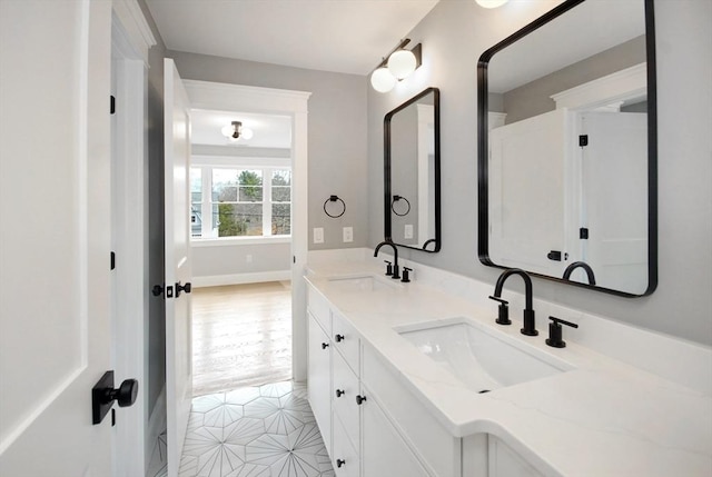 bathroom featuring double vanity, tile patterned flooring, and a sink