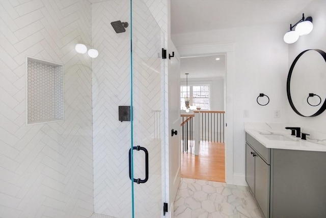 bathroom with a shower stall and vanity