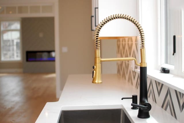 interior details featuring a sink and light stone counters