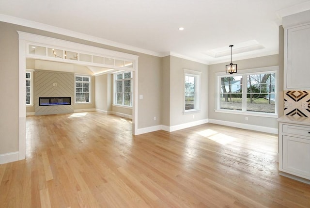 unfurnished living room with light wood finished floors and baseboards