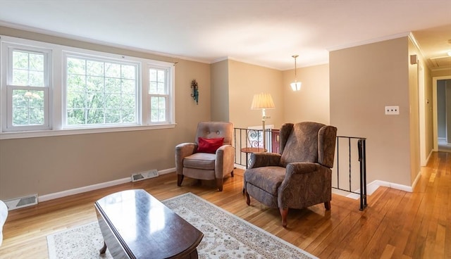 57 Mark Dr, Raynham, MA 02767 - sitting room with light wood finished floors, baseboards, and crown molding