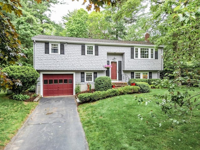 57 Mark Dr, Raynham, MA 02767 - raised ranch with a chimney, a garage, driveway, and a front lawn