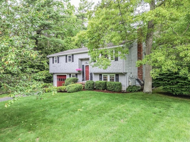 57 Mark Dr, Raynham, MA 02767 - split foyer home with a front yard, a chimney, and an attached garage