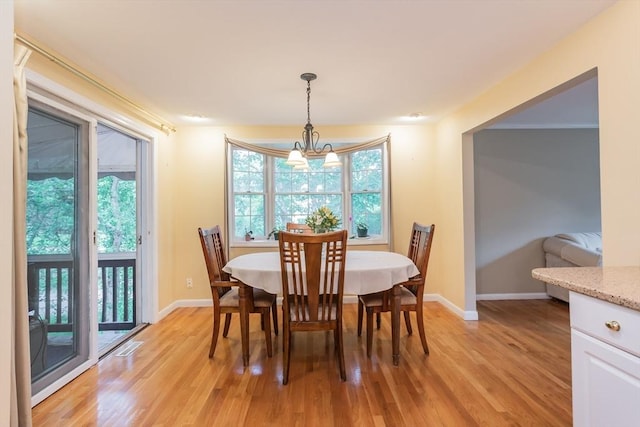 57 Mark Dr, Raynham, MA 02767 - dining space with light wood finished floors, a chandelier, and baseboards