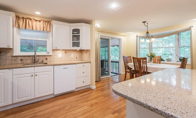 57 Mark Dr, Raynham, MA 02767 - kitchen featuring dishwasher, a sink, light wood-style floors, white cabinetry, and healthy amount of natural light