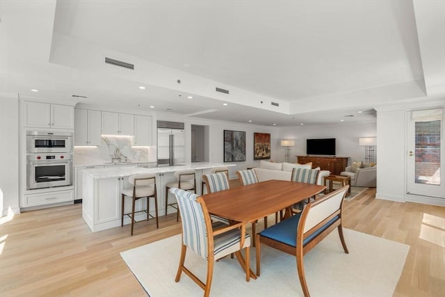 300 Boylston St Unit 907, Boston, MA 02116 - dining area featuring light wood-style floors, a tray ceiling, recessed lighting, and visible vents
