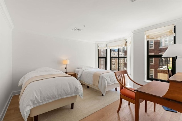 300 Boylston St Unit 907, Boston, MA 02116 - bedroom featuring crown molding, baseboards, wood finished floors, and visible vents