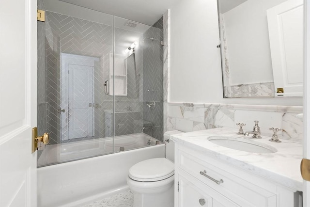 300 Boylston St Unit 907, Boston, MA 02116 - full bath with tile walls, vanity, a wainscoted wall, combined bath / shower with glass door, and toilet