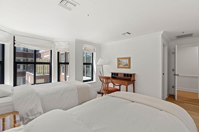 300 Boylston St Unit 907, Boston, MA 02116 - bedroom featuring ornamental molding, multiple windows, wood finished floors, and visible vents