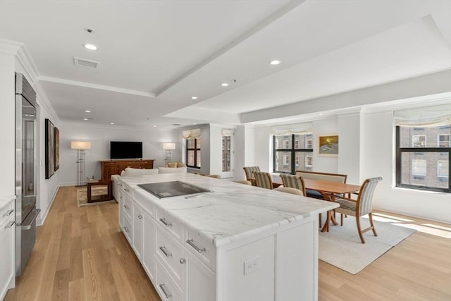 300 Boylston St Unit 907, Boston, MA 02116 - kitchen featuring light stone countertops, built in fridge, light wood finished floors, open floor plan, and white cabinetry