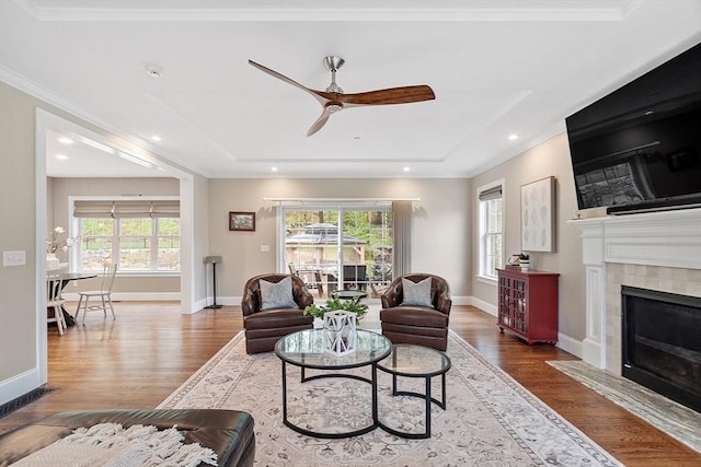 57 Houghton Farm Ln, Bolton, MA 01740 - living area featuring healthy amount of natural light, wood finished floors, ceiling fan, baseboards, and crown molding