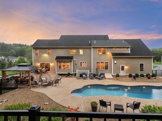 57 Houghton Farm Ln, Bolton, MA 01740 - back of property at dusk with a gazebo and a patio area
