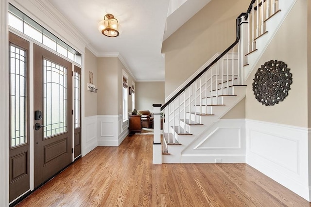 57 Houghton Farm Ln, Bolton, MA 01740 - foyer with wood finished floors, healthy amount of natural light, wainscoting, a decorative wall, and stairs