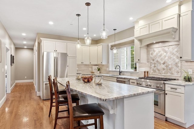 57 Houghton Farm Ln, Bolton, MA 01740 - kitchen with high quality appliances, a sink, recessed lighting, light wood-type flooring, and a kitchen island