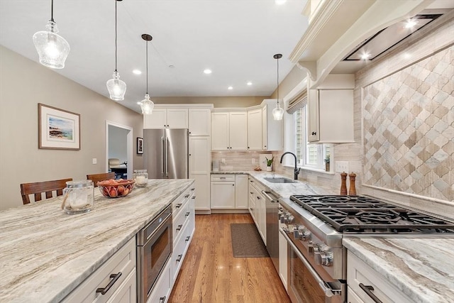 57 Houghton Farm Ln, Bolton, MA 01740 - kitchen featuring high quality appliances, a sink, light wood finished floors, light stone counters, and white cabinets