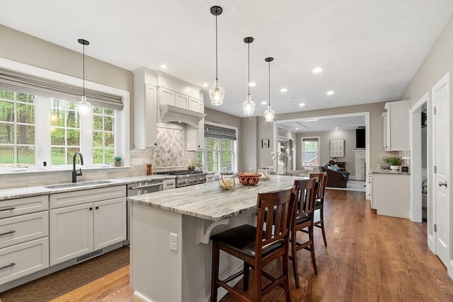 57 Houghton Farm Ln, Bolton, MA 01740 - kitchen with a sink, wood finished floors, white cabinetry, a breakfast bar, and recessed lighting