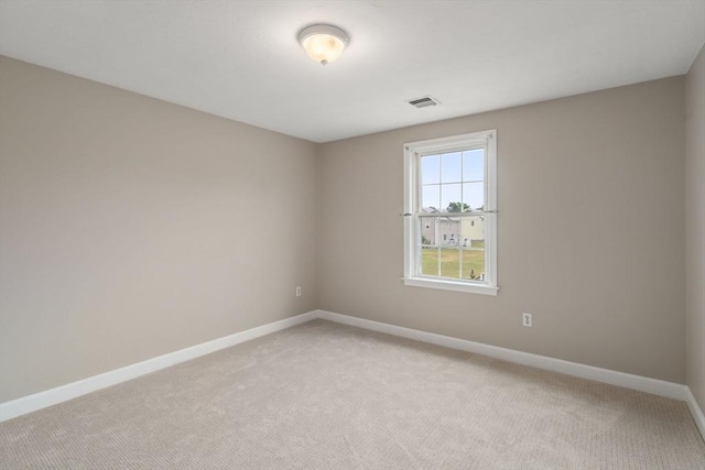 spare room with light colored carpet