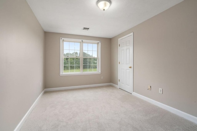 spare room with light colored carpet