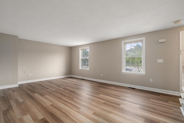 spare room featuring light hardwood / wood-style floors