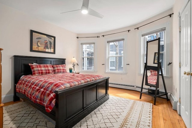 bedroom featuring light wood-style floors and a ceiling fan