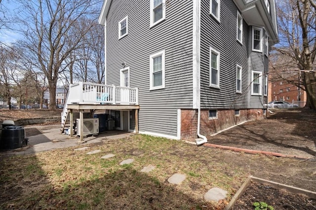 rear view of house featuring stairway, a deck, and ac unit