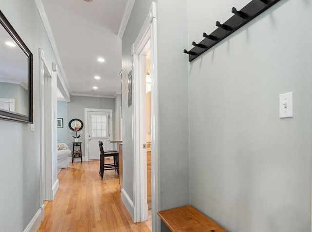 hall featuring crown molding, recessed lighting, baseboards, and light wood finished floors
