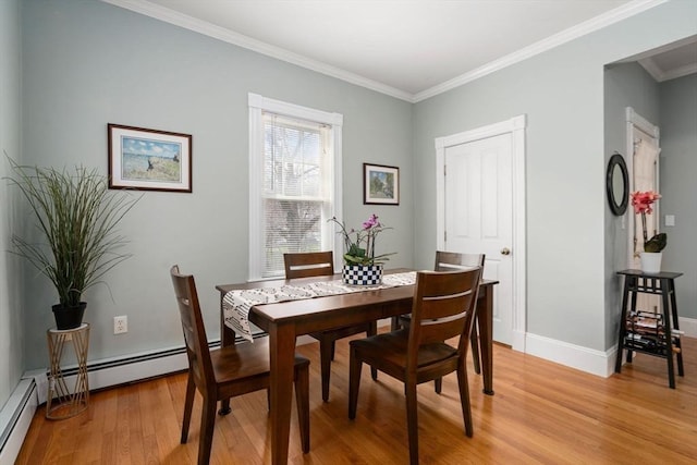 dining space featuring baseboards, ornamental molding, and light wood-style flooring