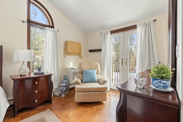 sitting room featuring baseboard heating, vaulted ceiling, a wealth of natural light, and french doors