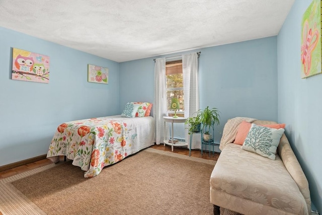 bedroom featuring a textured ceiling and baseboards