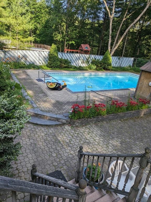 view of pool with a fenced in pool, fence, and a patio