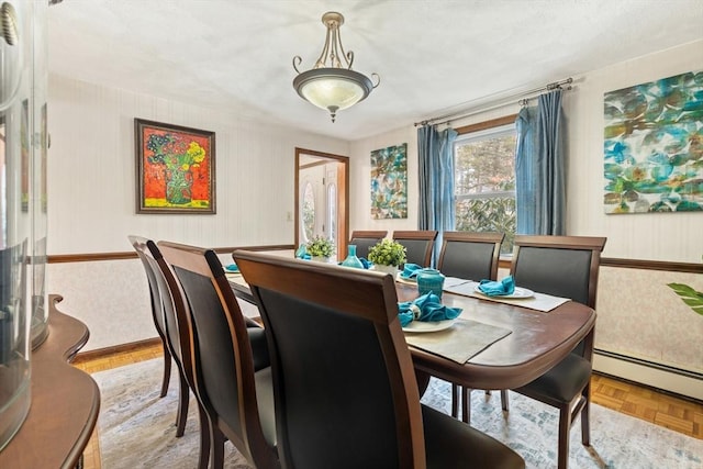 dining space featuring a baseboard heating unit