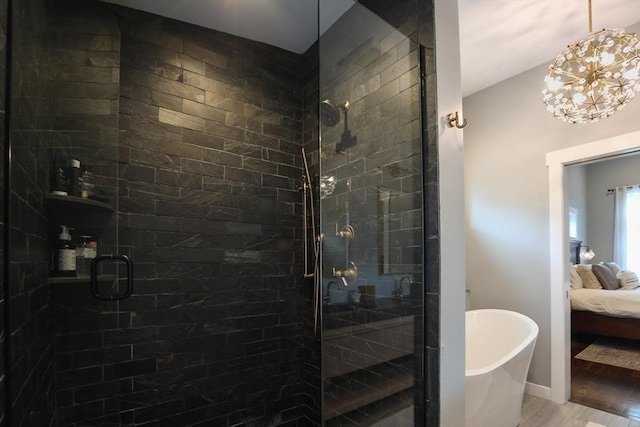 10 Wakefield Ave Unit A, Wakefield, MA 01880 - full bath with ensuite bath, a freestanding bath, a shower stall, wood finished floors, and a chandelier