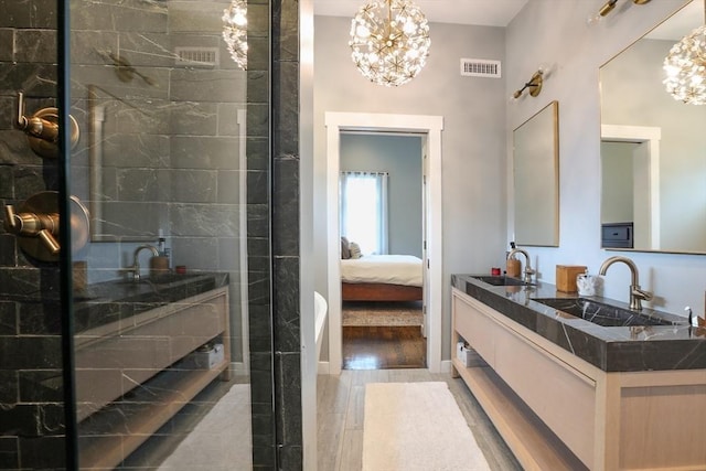 10 Wakefield Ave Unit A, Wakefield, MA 01880 - bathroom featuring a chandelier, double vanity, ensuite bath, and wood finished floors