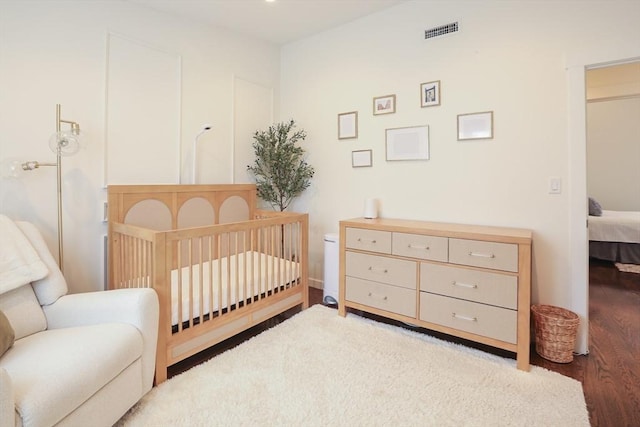 10 Wakefield Ave Unit A, Wakefield, MA 01880 - bedroom with wood finished floors and a nursery area