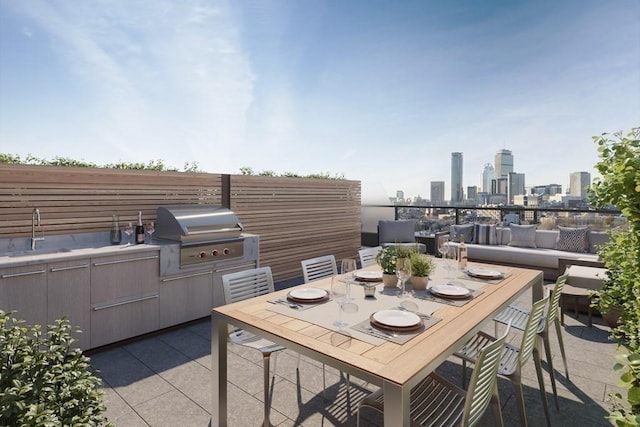 380 Harrison Ave Unit Ph1K, Boston, MA 02118 - view of patio / terrace with a sink, an outdoor hangout area, a view of skyline, and outdoor dining space
