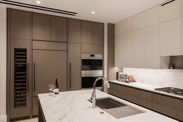 380 Harrison Ave Unit Ph1K, Boston, MA 02118 - kitchen with appliances with stainless steel finishes, modern cabinets, a sink, recessed lighting, and light stone counters