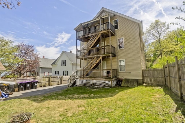 4 Columbia St, Holyoke, MA 01040 - rear view of property featuring a fenced backyard, stairs, a wooden deck, and a yard
