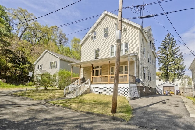 4 Columbia St, Holyoke, MA 01040 - view of front of house featuring a gambrel roof, a porch, an outbuilding, and aphalt driveway