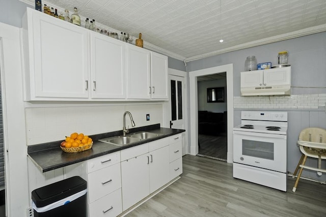 4 Columbia St, Holyoke, MA 01040 - kitchen with under cabinet range hood, white electric stove, a sink, decorative backsplash, and white cabinets