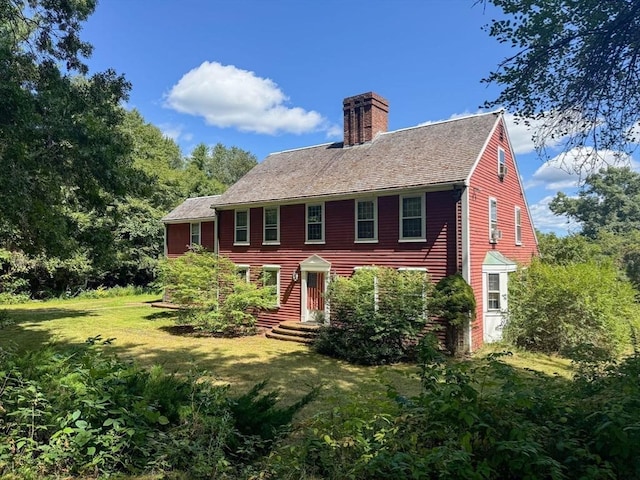 back of house with a lawn