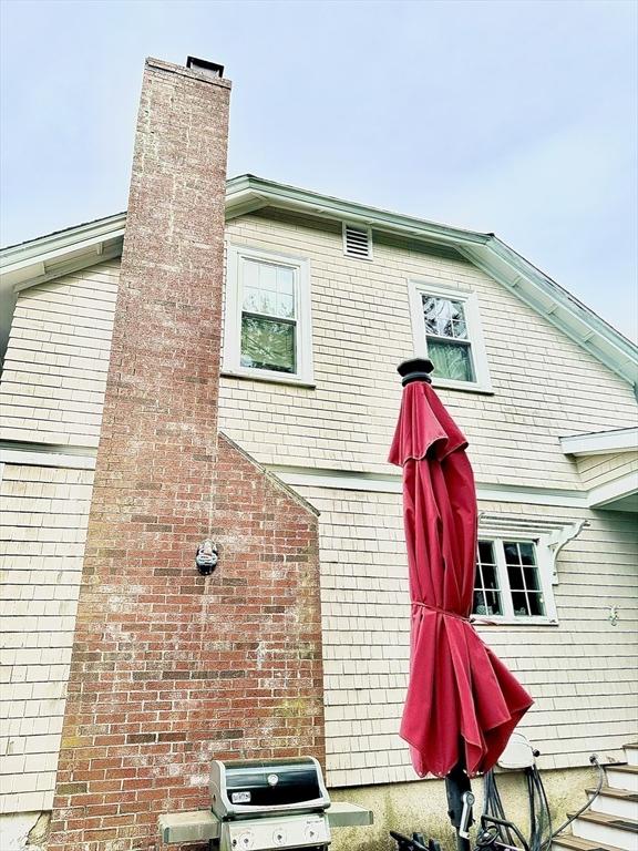 11 Moynan St, New Bedford, MA 02745 - view of property exterior with a chimney and brick siding