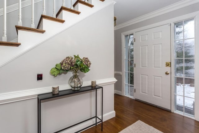 foyer with dark hardwood / wood-style floors and ornamental molding