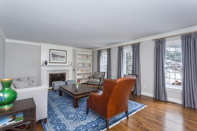 living room with dark hardwood / wood-style floors and ornamental molding