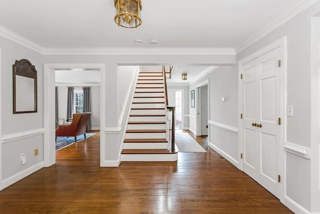 foyer featuring dark hardwood / wood-style flooring and crown molding