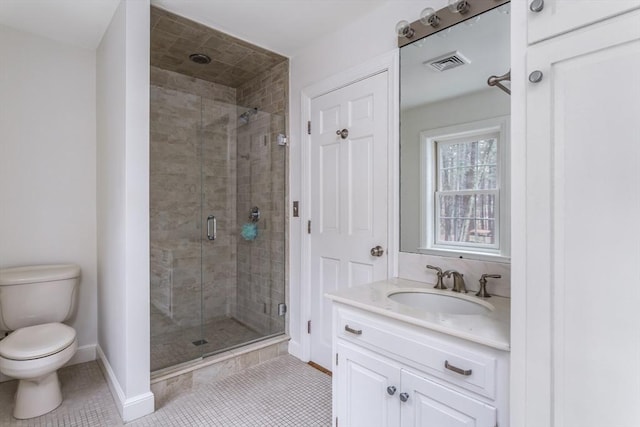 bathroom featuring tile patterned flooring, vanity, toilet, and an enclosed shower