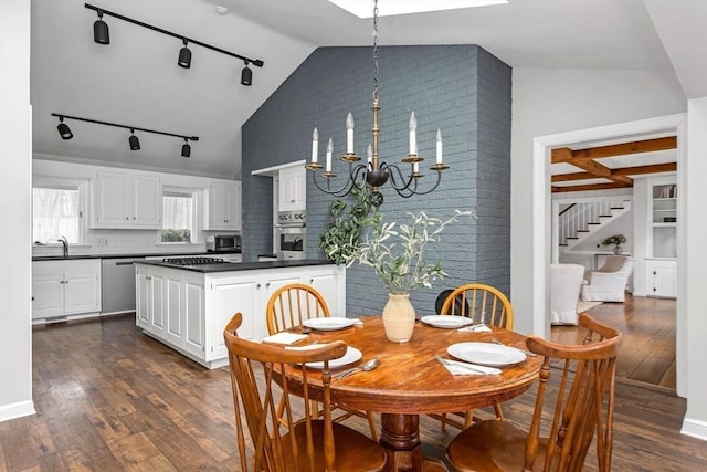 dining space with lofted ceiling, sink, dark wood-type flooring, and a notable chandelier