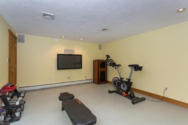 exercise area featuring a textured ceiling and a baseboard heating unit