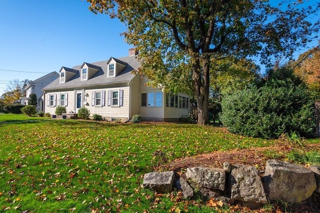 new england style home with a front lawn