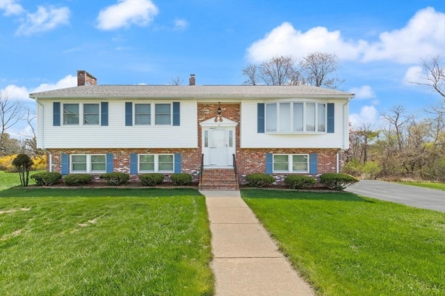 11 Ocean View Dr, Gloucester, MA 01930 - split foyer home with brick siding, a front lawn, and a chimney